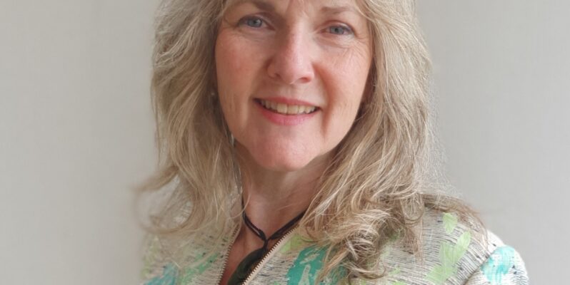 Katherine Dewar - founder at B Corp GoodSense shown smiling to camera in cream and blue jacket