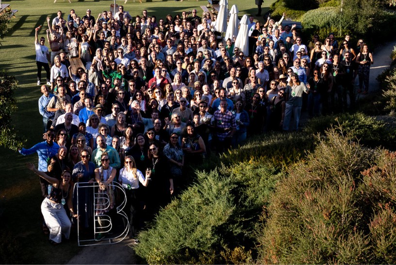 Large crowd of people from B Corps smiling up at a camera including GoodSense marketing founder Katherine Dewar